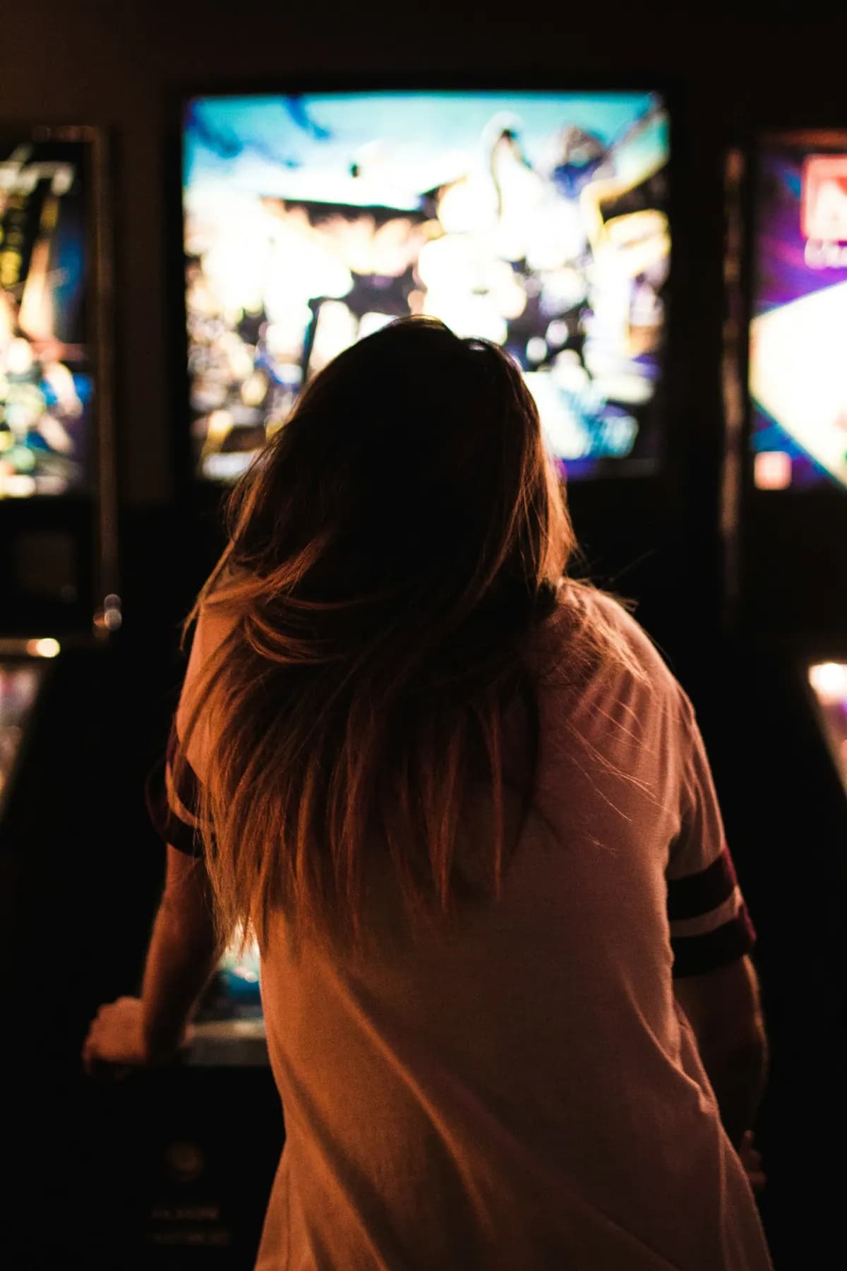 A guest playing inside an arcade and entertainment venue